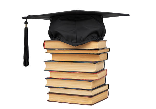 istock Isolated Graduation Cap on Stack of Books - Academic Achievement 2228671051