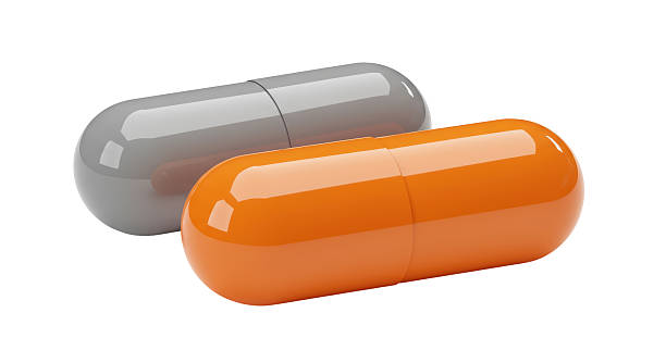 istock Isolated Orange and Grey Pharmaceutical Capsules 2228673044