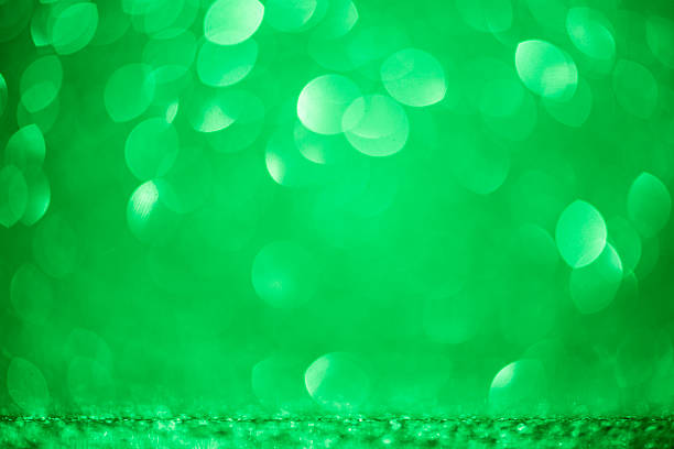 istock Soft green color bokeh circles float over an abstract textured backdrop with a smooth color gradient, creating ideal copy space for web banner and header  design element templates. 2228675092