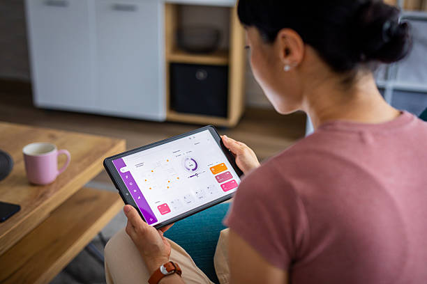 istock Woman Using Smart Home Control App on a Digital Tablet 2228677445