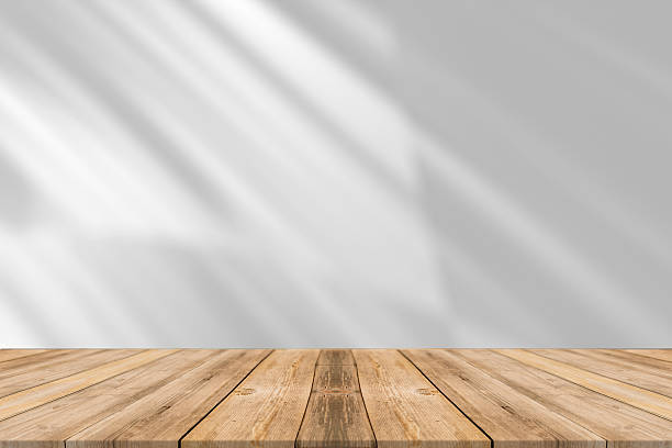 istock A wooden tabletop with a white wall and sunlight shining through the window. 2228678006