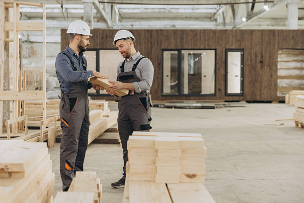 istock Construction workers examining wooden plank in modular building factory 2228678186
