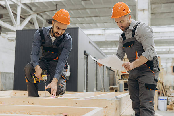 istock Construction workers building wooden frame house in factory 2228678245