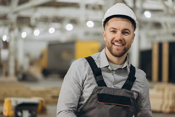 istock Smiling engineer wearing hardhat in modular building factory 2228678279