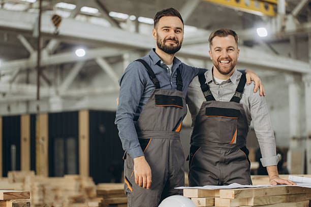 istock Engineers hugging and smiling in modular building factory 2228678304