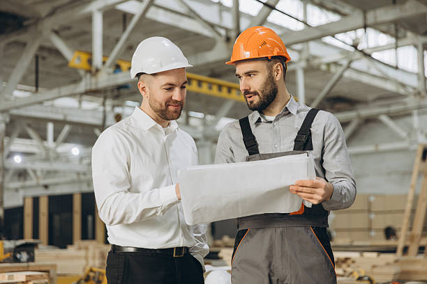 istock Engineers reading blueprint in modular building factory 2228678403