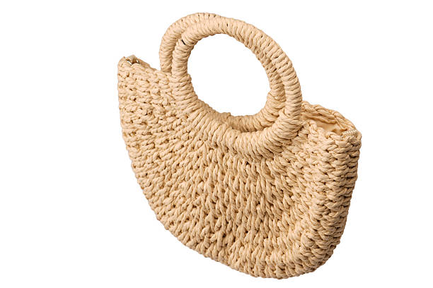 istock A beige straw bag isolated on a white background. 2228678586