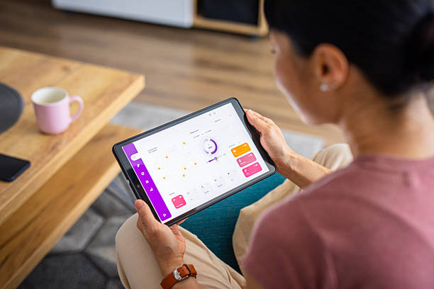 istock Woman Using Smart Home Control App on a Digital Tablet 2228678817