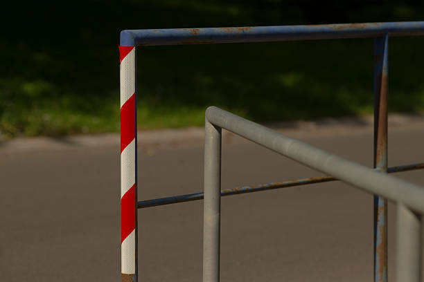 istock There is a red and white striped pole firmly positioned on a metal railing 2228678821