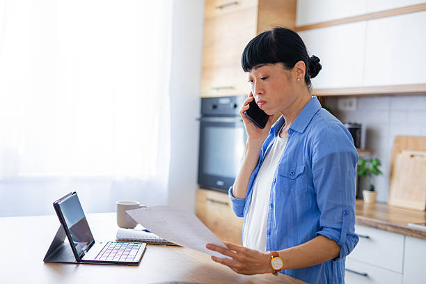 istock Stressed Female Discussing Finances Over a Phone Call at Home 2228678928