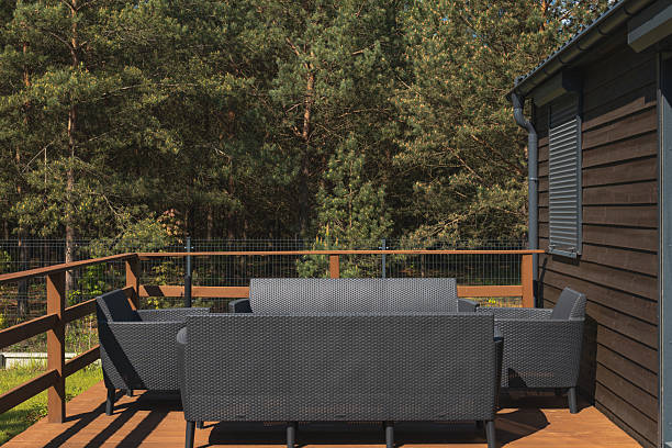 istock Wooden Deck with Modern Furniture Surrounded by Pine Forest 2228679643