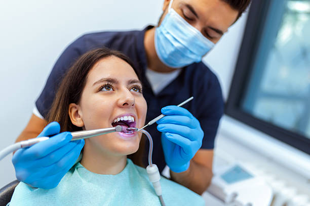 istock Male Dentist Treating Female Patient's Teeth 2228679738