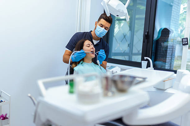 istock Male Dentist Treating Female Patient's Teeth 2228679873