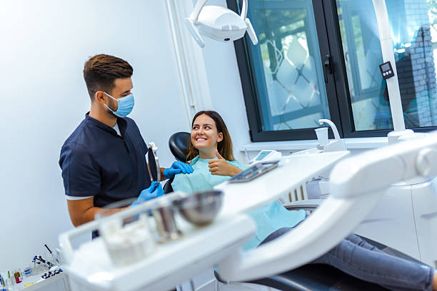 istock Male Dentist Treating Female Patient's Teeth 2228679967