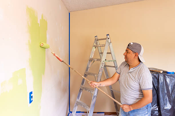 istock Man painting his bedroom with a roller 2228683146