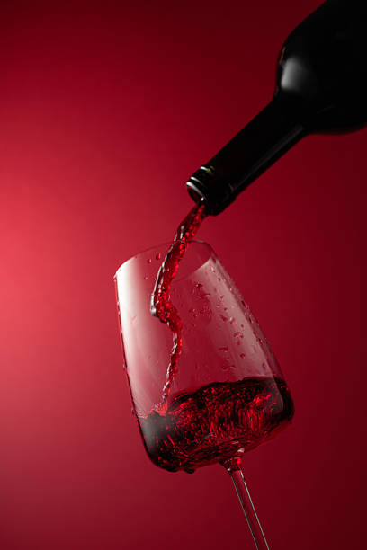 istock Pouring red wine from a bottle into a glass. 2228684371