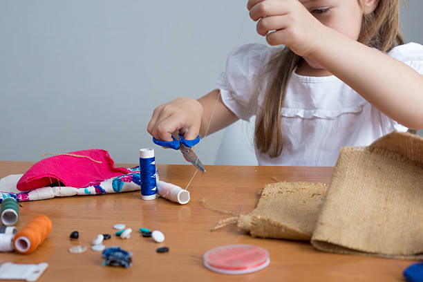 istock Girl crafting patchwork with fabric and thread 2228684771