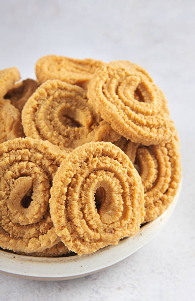 istock Indian chakli (murukku) snacks on white background. Traditional crispy spiral Diwali snack. 2228687247