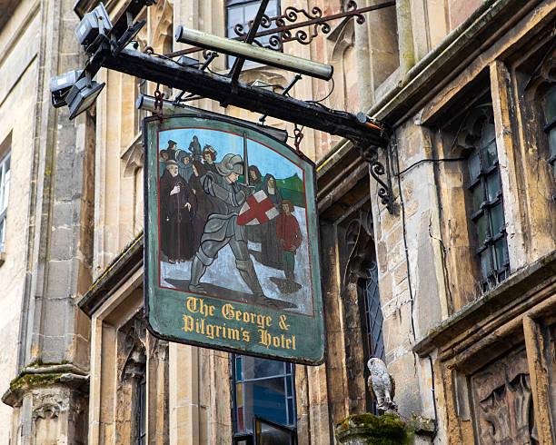 Glastonbury, UK - May 1st 2024: The traditional hanging sign on the exterior of the George and Pilgrims Hotel, in the town of Glastonbury in Somerset, UK.