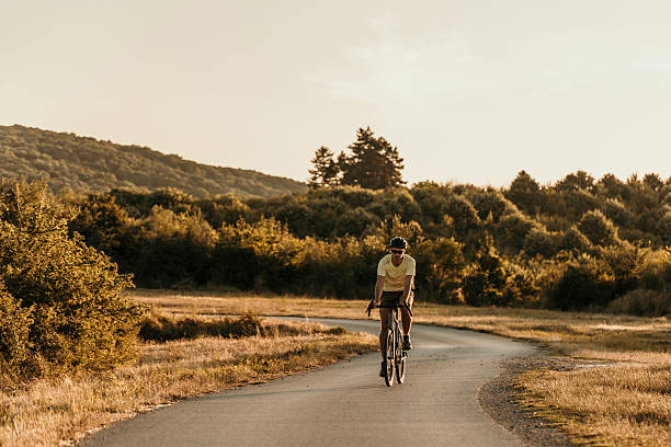 istock Cyclist enjoying a summer ride on a scenic road at sunset 2228688741