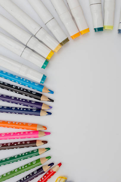 Bright school and office supplies including scissors, pens, pencils, sticky notes, paper clips, and markers scattered on a white surface.