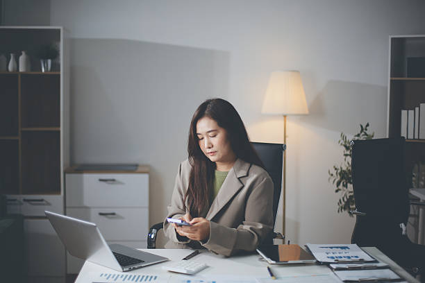 istock A Happy Beautiful Blonde Businesswoman Using Her Mobile Phone While Working In The Office 2228690059