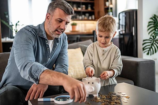 istock Father and son saving money together at home 2228691088