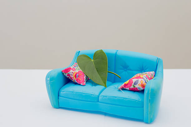 Happy African American young couple moving a sofa - isolated over a white background