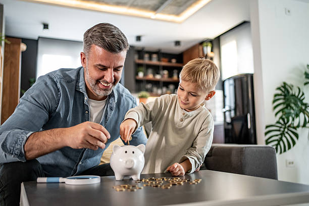 istock Father and son saving money together at home 2228692061