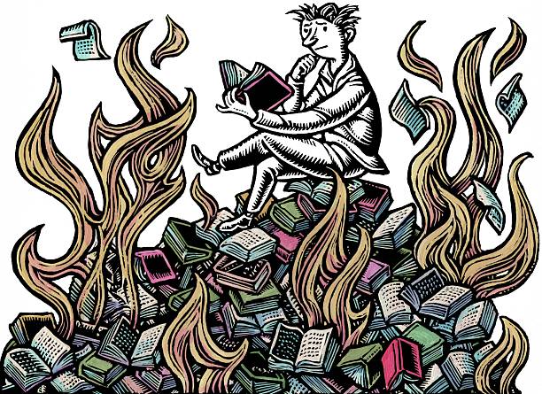 man sits reading on pile of burning books in the middle of the flames