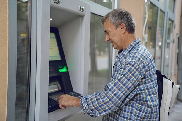 istock Senior Man Using ATM – Banking, Technology and Everyday Finance 2228695311