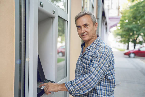 istock Senior Man Using ATM – Banking, Technology and Everyday Finance 2228695411