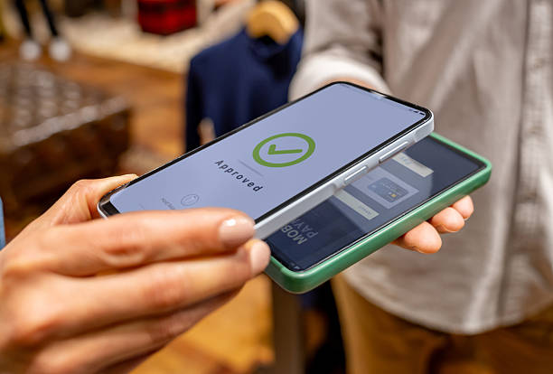 istock Close-up on a customer making a mobile payment at a clothing store 2228695414