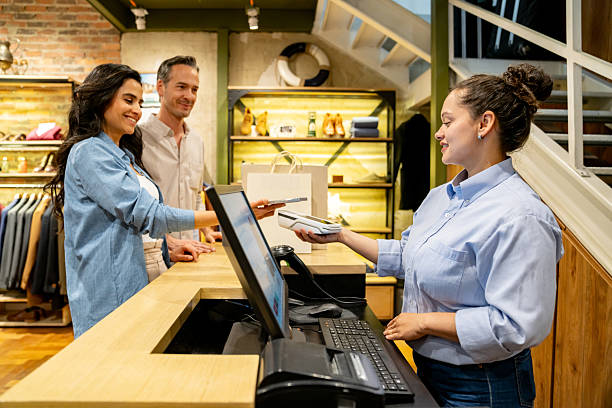 istock Couple making a mobile payment at a clothing store 2228695458