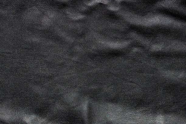 istock texture of black colored raw leather background 2228698012