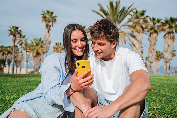 istock Happy couple enjoying time together while using a smartphone to capture special moments outdoors 2228699213