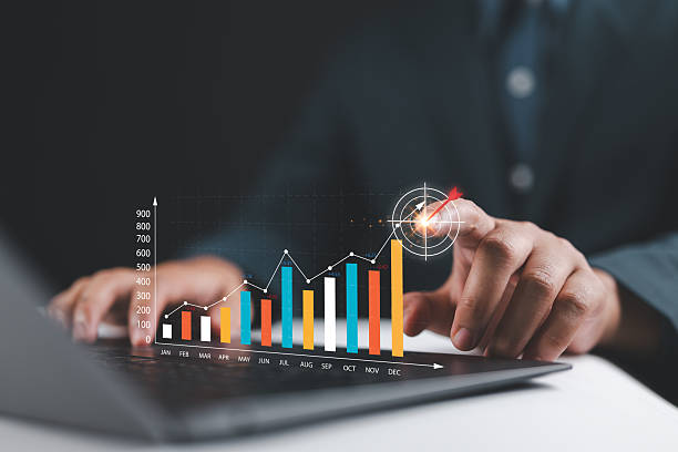 istock Businessman analyzing company's financial balance sheet working with digital augmented reality graphics. Businessman using laptop calculates financial data for long-term investment. 2228701296