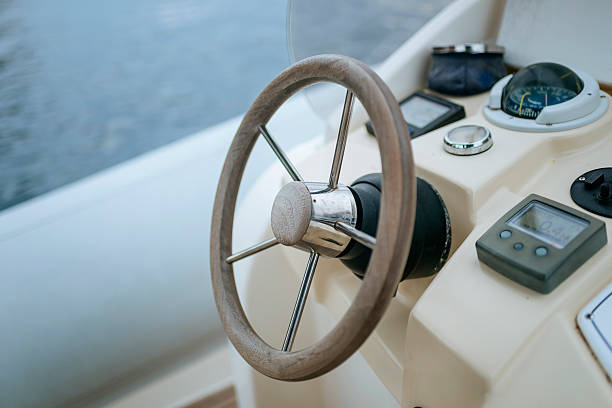 istock Wooden steering wheel and navigation instruments on a yacht 2228702943