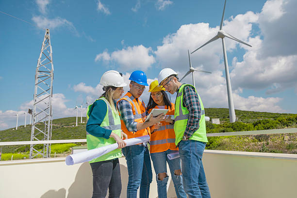 istock Engineers and Architects Collaborating with Digital Tablet at a Wind Farm for Renewable Energy and Sustainability Projects 2228703165