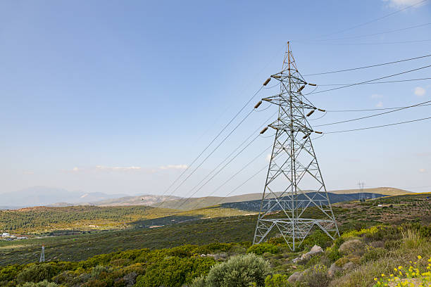 istock High Voltage Electricity Transmission Tower on Green Landscape Under Blue Sky 2228703200