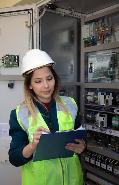 istock Confident Female Engineer Conducting Maintenance and Technical Inspection in High-Tech Control Room of Renewable Energy Power Station 2228703228