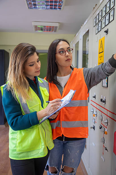 istock Two Female Engineers Collaborating on Technical Inspection in Control Room of Renewable Energy Facility 2228703259