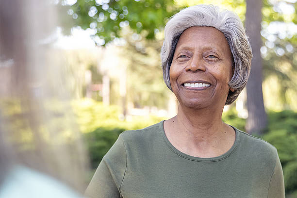 istock Senior best friends chatting in a park - view over shoulder 2228709531