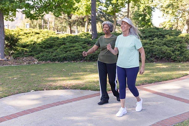 istock Two senior women walking in a public park 2228709560