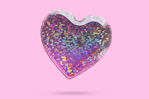 istock Pink heart shape hologram sticker flying on pink background 2228712946