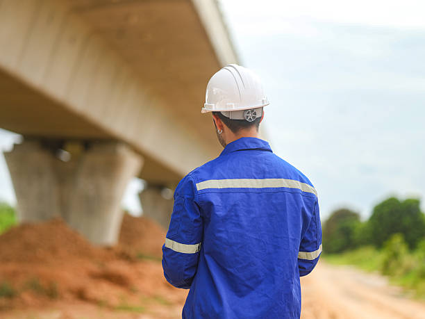 istock Asian engineer working at site of a large building project,Thailand people,Work overtime at construction site 2228713783