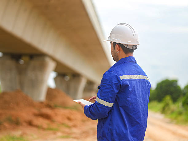 istock Asian engineer working at site of a large building project,Thailand people,Work overtime at construction site 2228713786