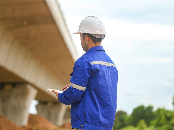 istock Asian engineer working at site of a large building project,Thailand people,Work overtime at construction site 2228713789