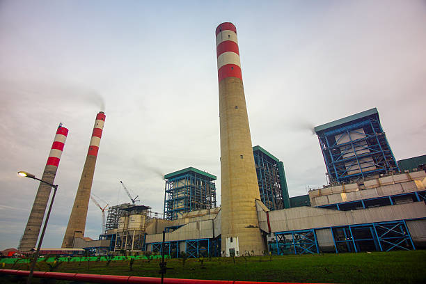 istock Industrial landscape displaying a power plant with towering chimneys and infrastructure against a cloudy sky creating an atmosphere of energy 2228720719