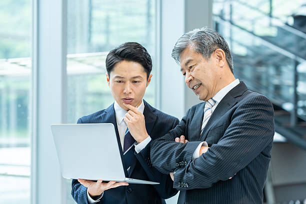 istock Businessmen in work clothes having a meeting 2228721599